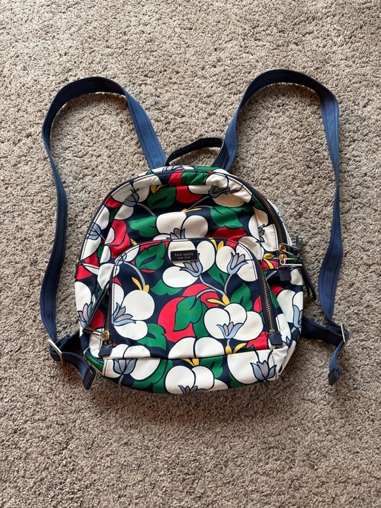 kate spade navy floral mini backpack with white blossoms and green leaves